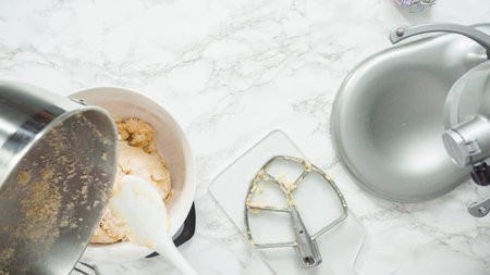 Step by step. Flat lay. Mixing ingredients in standing kitchen mixer to bake sugar cookies.