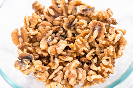 Close up of walnut halves in a glass bowl.