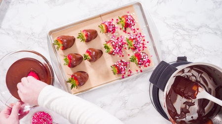 Flat lay. Step by step. Garnishing chocolate dipped strawberries with sprinkles.