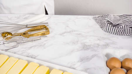 Step by step. Mixing ingredients in a glass bowl to make chocolate chip cookies.の写真素材