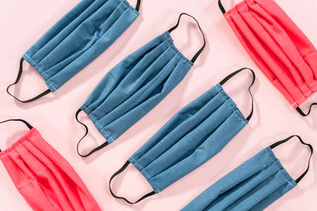 Homemade face masks for coronavirus outbreak on a pink background.の写真素材