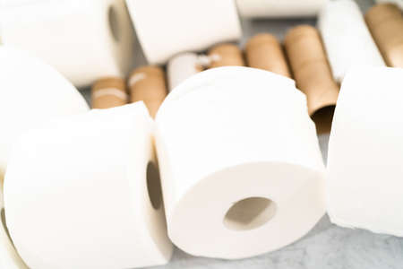 New and empty white toilet paper rolls on a gray background.の写真素材