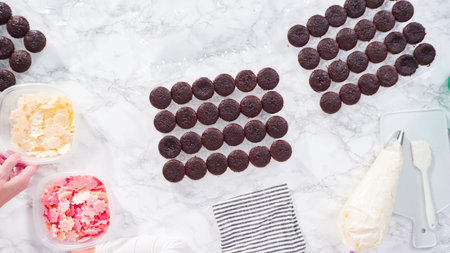 Flat lay. Step by step. Piping Italian buttercream frosting on top of mini chocolate cupcakes.