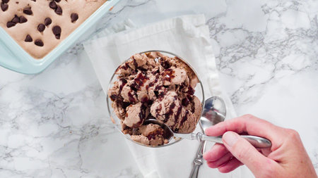 Flat lay. Homemade chocolate ice cream garnished with chocolate in a glass ice cream bowl.