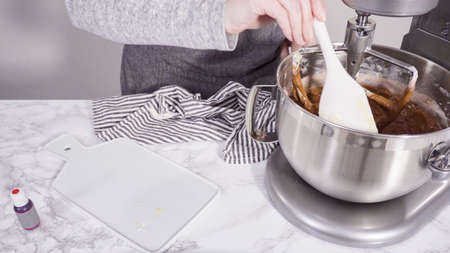 Step by step. Mixing ingredients in a standing kitchen mixer to bake red velvet cupcakes.の写真素材