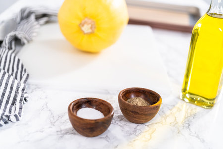 Preparing organic spaghetti squash with olive oil, salt, and pepper.の写真素材