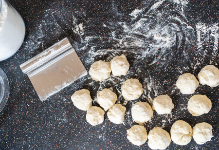 Preparing bread dough on the kitchen counter to bake flatbread.の写真素材