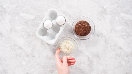 Flat lay. Step by step. Ingredients in glass mixing bowls to prepare chocolate mug cakes.