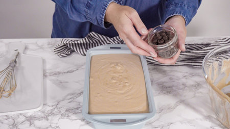Step by step. Garnishing homemade chocolate ice cream with chocolate chips.