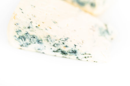 Large slice of blue cheese on a white background.
