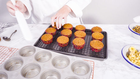 Step by step. Garnishing banana bread muffins with homemade caramel, banana chips, and walnuts.