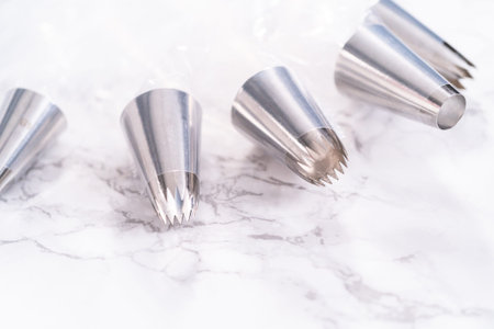 Icing metal tips in piping bags for decorating a cake.の写真素材