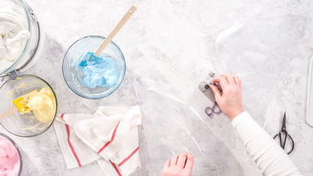 Flat lay. Step by step. Transfering meringue mix into piping bags with metal tips to bake unicorn...