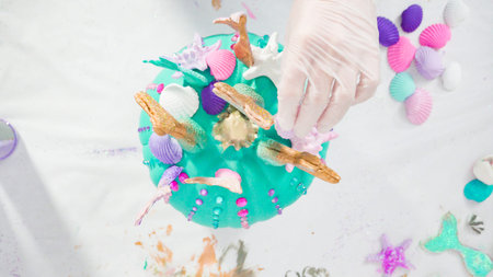 Flat lay. Step by step. Decorating art pumpkins with rhynestones, mermaid tails, and seashells in...