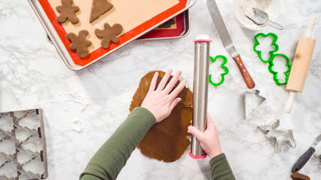 Flat lay. Step by step. Rolling out gingerbread cookie dough to bake Christmas cookies.の写真素材