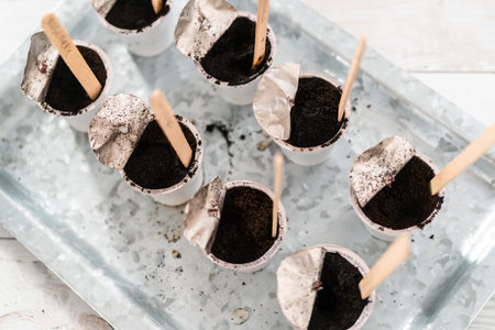 Planting seeds into coffee pods to start an indoor vegetable garden.