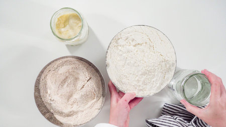 Flat lay. Measuring ingredients into a glass bowl to bake cinnamon rolls.