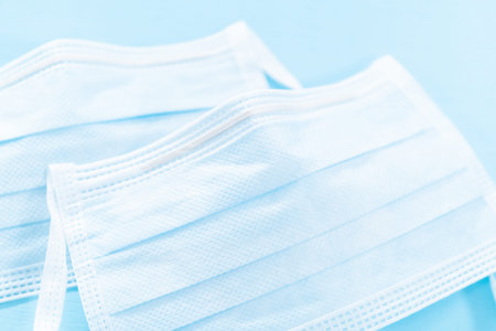 Medical blue masks for coronavirus outbreak on a blue background.
