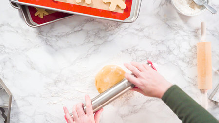 Flat lay. Step by step. Rolling out sugar cookie dough to bake Christmas cookies.の写真素材