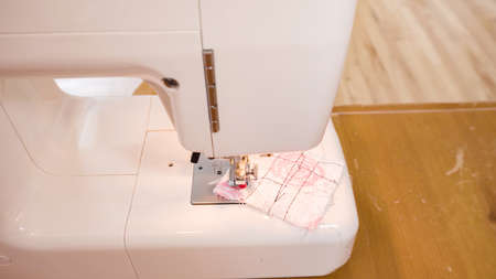 Sewing cotton face mask with a sewing machine for coronavirus outbreak.の写真素材