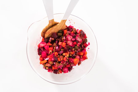 Flat lay. Mixing ingredients in the glass mixing bowl to make a vinaigrette salad.