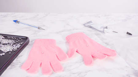 Rhinestone pink kids gloves with snowflake shapes.の写真素材