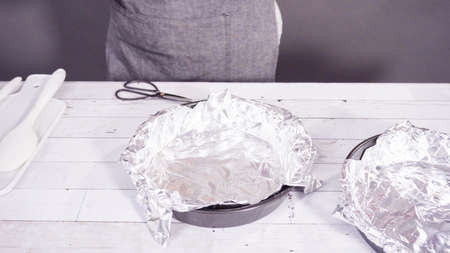 Step by step. Lining the baking pan with cooking foil to make homemade fudge.の写真素材