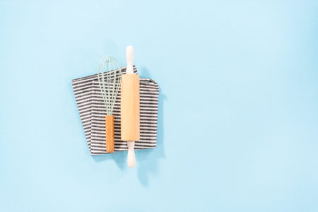 Flat lay. New blue silicone kitchen utensils with wooden handles