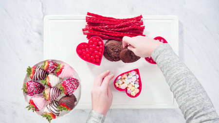 Flat lay. Step by step. Cheese board with candies and cookies for Valentines Day.