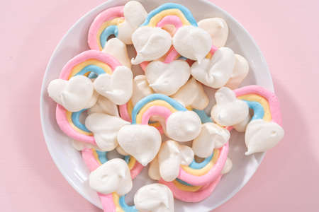 Gourmet unicorn theme meringue pops on a pink background.の写真素材