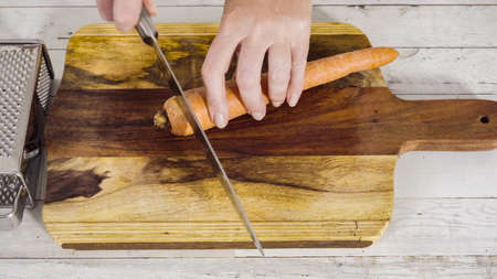 Grated organic orange carrots on a wood cutting board.の写真素材