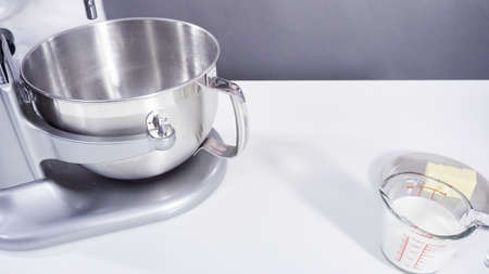 Ingredients on a white kitchen counter to bake cinnamon rolls.の写真素材