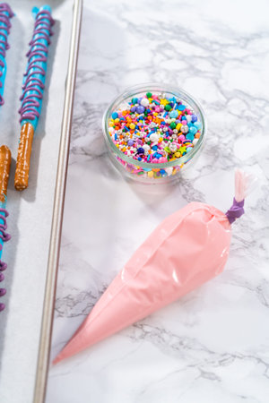 Melted pink chocolate in a piping bag, ready for drizzling.の写真素材