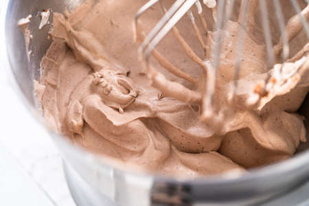 Mixing ingredients in a standing kitchen mixer to make homemade chocolate ice cream.の写真素材