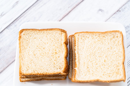 Stack of texas toast on a white plate, ready to prepare french toast.の写真素材