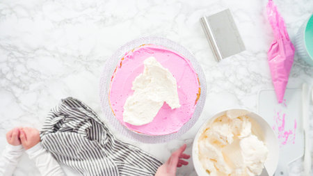 Flat lay. Step by step. Frosting round funfetti cake with white italian buttercream frosting.