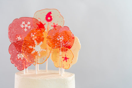 Close up of large clear pink and white lollipops with snowflakes and sprinkles.
