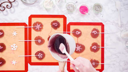 Flat lay. Step by step. Pouring caramelized sugar on a silicone baking mat to make homemade lollipops.の写真素材