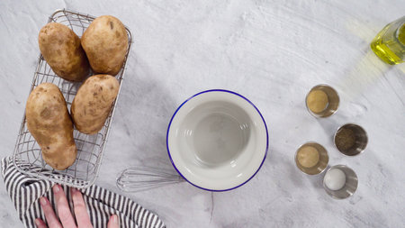 Flat lay. Step by step. Ingredients on the counter to prepare potato wedges with spices.の写真素材