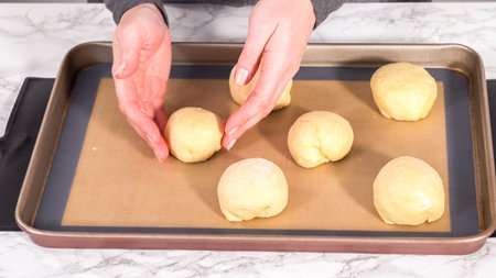 Step by step. Rising brioche dough on a baking sheet with a silicone mat.