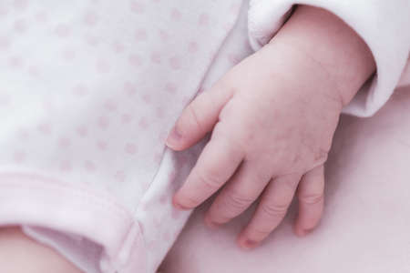 Lifestyle portrait of a newborn, three weeks old baby girl.の写真素材