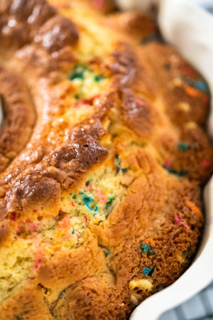 Close up view. Cooling freshly baked funfettti bundt cake on a wire rack.