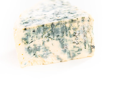 Large slice of blue cheese on a white background.の写真素材