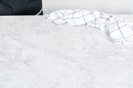 White kitchen towel on the empty stone kitchen counter.の写真素材