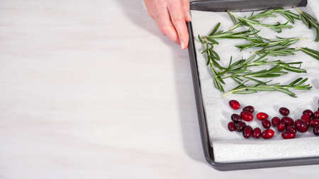Step by step. Covering fresh cranberries and rosemary in sugar to decorate chocolate bundt cake with chocolate frosting.の写真素材