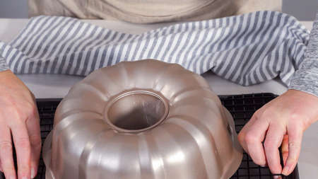 Step by step. Cooling freshly baked chocolate bundt cake on a cooling rack.の写真素材
