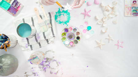 Flat lay. Step by step. Painting craft pumpkin with acrylic paint to create decorated mermaid Halloween pumpkin.の写真素材