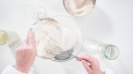 Flat lay. Measuring ingredients into a glass bowl to bake cinnamon rolls.