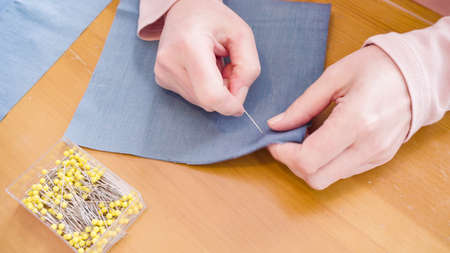 Sewing cotton face mask with a sewing machine for outbreak.の写真素材