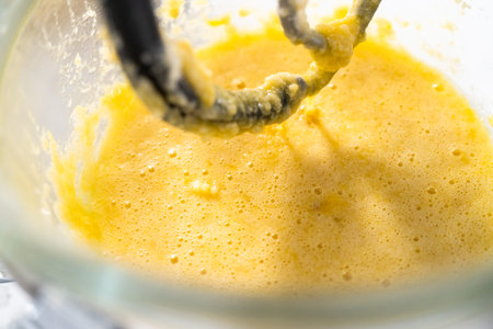 Mixing ingredients into the batter for lemon pound cake.